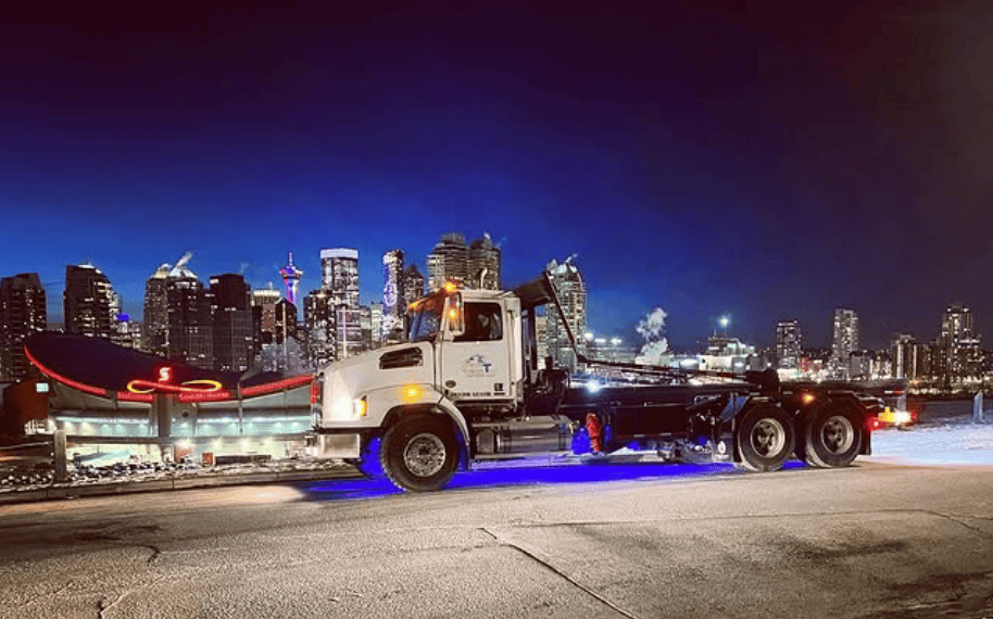 Professional waste management team with dumpster rental trucks - Alberta dumpster rental services